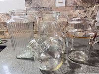 Group shot of four glass pitchers on countertop