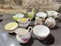All five cream and sugar sets arranged together on countertop