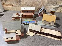 All six model railroad buildings arranged on countertop