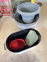 Overall lot showing beverage tub with red bowl and green tray, and nested planters behind