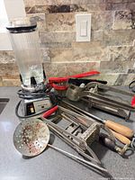 Group view of blender and assorted metal kitchen tools showing overall condition