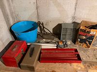 All items on table including toolboxes, trays, light, tub, organizer, jack, box
