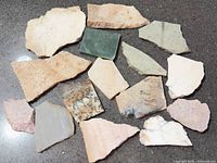 All 16 stone pieces on dark surface