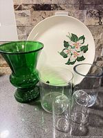 Group shot showing platter, green vase, three clear vases and two bud vases