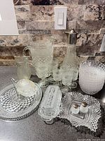 Group shot of all pressed-glass items on countertop