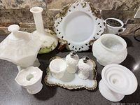 Group shot of all eleven milk glass pieces arranged on countertop