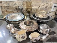 Group shot showing entire assortment of pewter, silverplate, ceramic and glass items