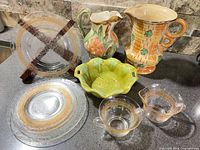 Group shot of all pitchers, plates, bowl, glassware displayed