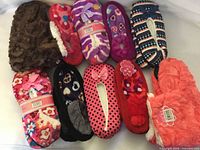 All ten pairs assorted plush slippers displayed side by side
