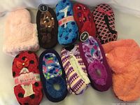 Group shot of all ten slipper pairs displaying variety of colours, patterns and styles