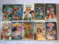 Group shot of all 10 Disney VHS clamshell cases laid out in two rows