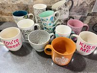 Group shot of all mugs and bowl on countertop
