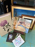 Group shot showing majority of canvases and framed pieces