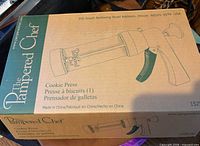 sealed Pampered Chef cookie press box showing branding and product illustration