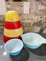 Stack of four solid-colour mixing bowls plus two turquoise Butterprint bowls