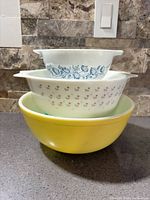 Stacked view of all three Pyrex bowls showing sizes and patterns
