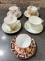 Group of five teacup and saucer sets