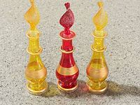 Front view of three coloured glass perfume bottles