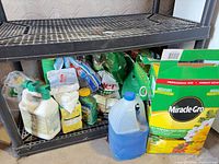 Shelf with assorted fertilizers, chemicals, jug and bags