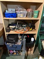 Overview of shelf with hardware containers, cords and other items