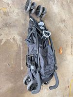 Folded black Summer 3D Lite stroller showing frame, wheels, and handles