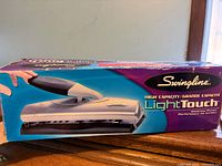 Retail box showing Swingline LightTouch high capacity desk punch graphics