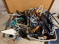 Top view of two storage totes filled with mixed hangers