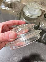 Close-up of lid showing missing seal ring and molded knob