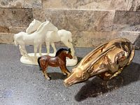 All three figurines together for scale and contents