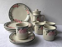 Full set arranged showing plates, mugs, teapot, creamer, sugar bowl