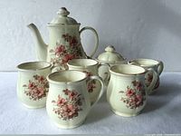 Entire set showing pot, creamer, sugar bowl and four mugs
