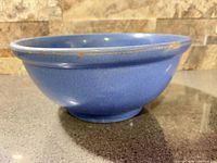Full view of blue glazed Medalta mixing bowl showing shape, glaze, and rim wear