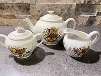 Teapot, sugar bowl, and creamer together