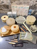 Full lot overview showing all vanity containers, grooming tools, hair nets, and accessories