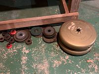 Group of assorted weight plates and collars on floor