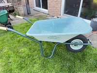 Full side view of wheelbarrow showing tray, frame and wheel