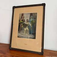 Full view of framed photograph showing frame style and tear at bottom