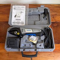 Full kit in carry case showing saw, blades, guide, dust adapter and manuals