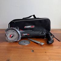 Zipsaw, carry bag, spare blade, wrench and handle displayed on table