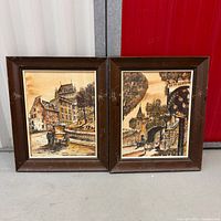 Both framed lithographs side by side