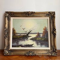 Front view of framed oil landscape painting