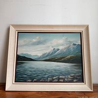 Framed mountain lake painting front view