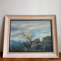 Frontal view of framed oil painting showing goats and landscape