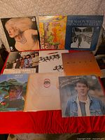 Front view of nine record albums arranged in three rows