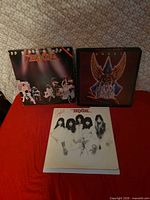Front view of three Angel vinyl LP albums: Live Without a Net, Helluva Band, Sinful