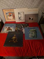 Seven Cat Stevens LPs spread on red surface showing front jackets