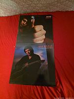 Front covers of both Don McLean albums on red background