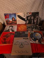 Overall shot showing nine record albums with visible covers