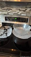 All three glass serveware items on stovetop