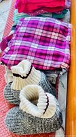 Stack of plaid pants and knit slipper socks